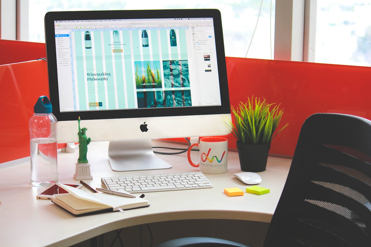 A contemporary office desk setup with a computer, accessories, and vivid colors.